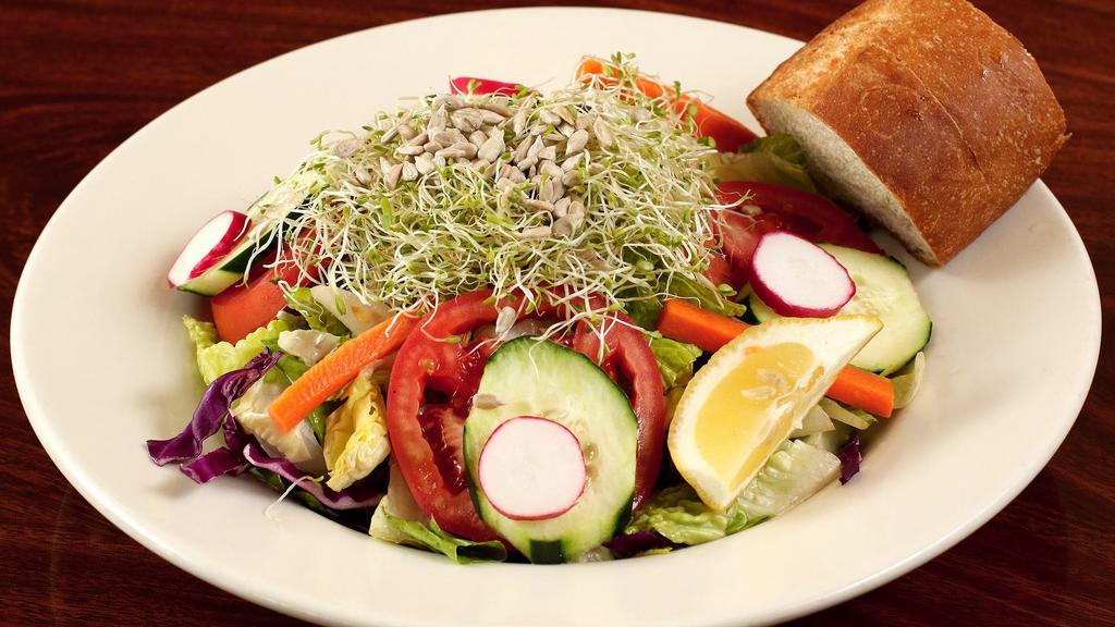 Garden Salad · Romaine hearts lettuce, roma tomatoes, sprouts, sun flower seeds and red cabbage. Tossed with house vinaigrette dressing.