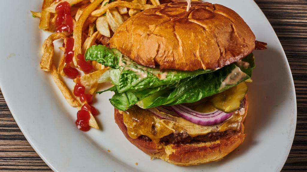 The Classic Burger · Half pound fresh meat, our house sauce, lettuce, tomato, pickles, and onions.