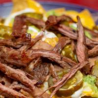 Super Nachos · Homemade Chips (Fries-upon request), meat, refried beans, guacamole, sour cream, 2 kinds of ...