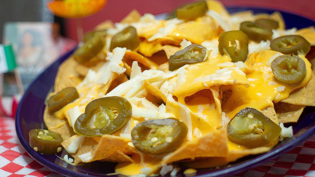 Nachos · Homemade chips, jalapenos and cheese.