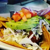 Fish Tacos · Grilled or Battered cod fish topped with cabbage, cilantro, tomato, onions, fresh avocado an...