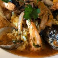 Chipotle Sea Bass · Mussels, sea bass, chipotle broth, clams, calamari, and white rice.
