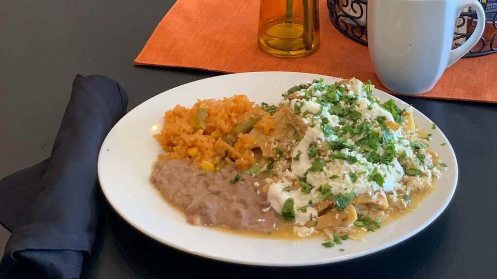 Chilaquiles · Chilaquiles with  Green or Red salsa, served with 2 Fried Eggs, Rice and Re-fried  Beans.