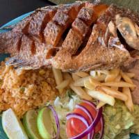 Mojarra Frita · Fried Tilapia, served with Rice, Re-fried Beans, Salad, Fresh Guac and French Fries.