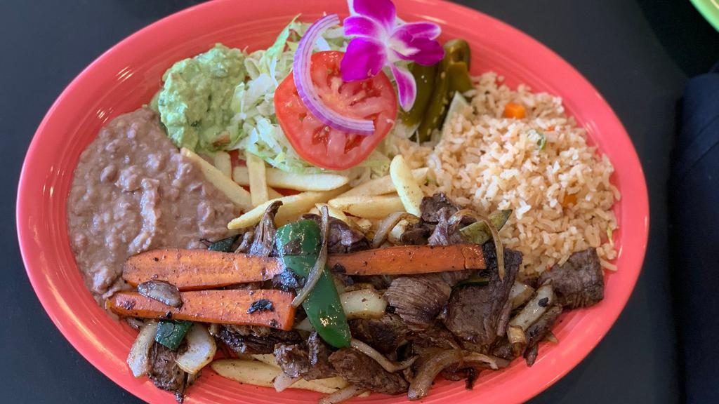 Platillo de Carne Asada · Grilled Steak seasoned with Onions, Jalapeños, Carrots, Zucchini, served with Rice, Re-fried Beans, Salad and French Fries.