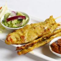 Chicken Satay · Five skewers. Marinted chicken on skewers served with peanut sauce and small cucumber salad.