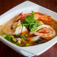 Bowl of Tom Yum Soup · Serves 3-4 people. Hot and sour soup with mushrooms, tomatoes, lemon grass, kaffir leaves, a...