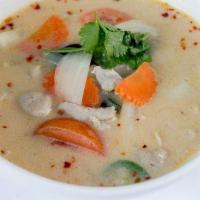 Cup of Tom Kha Soup · Coconut milk soup with mushrooms, galanga, onion, tomato, lemon grass, and lime juice.