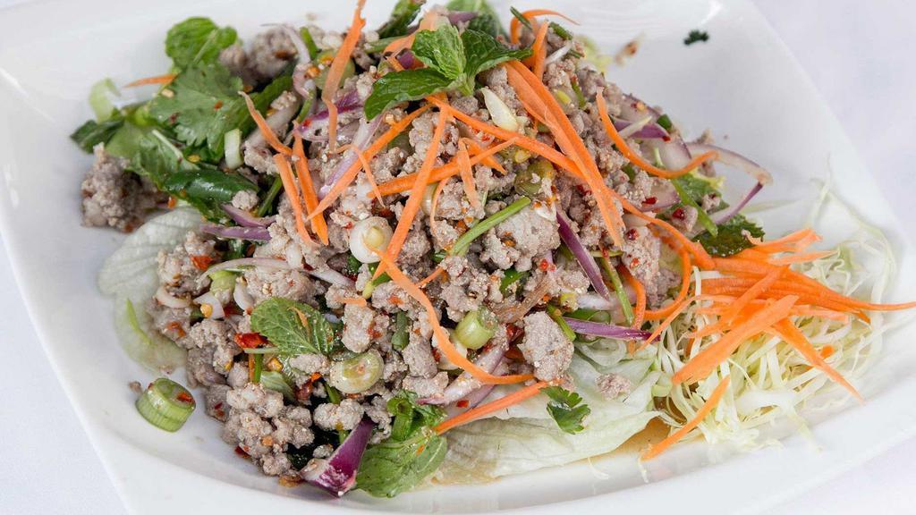 Larb Salad · Choice of chicken, pork, or beef. Minced with onions, mint leaves, cilantro, roasted rice powder, and spicy lime dressing on a bed of lettuce.