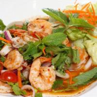 Prawns Salad · Charbroiled prawns seasoned with spicy lime dressing, mint leaves, and lemon grass.