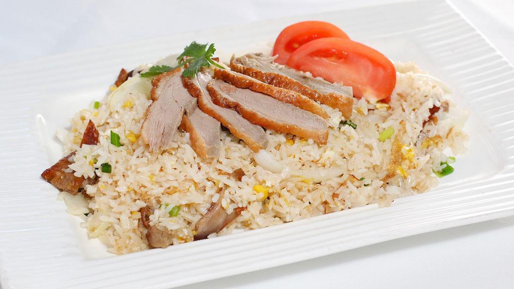 Duck Fried Rice · Steamed jasmine rice stir fried with boneless roast duck egg, tomatoes, green onion, and Thai seasoning sauce with crab paste.