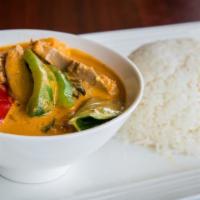 35. Red Curry Over Rice · Medium spicy curry cooked with coconut milk, sweet basil, bell pepper, and bamboo shoot.