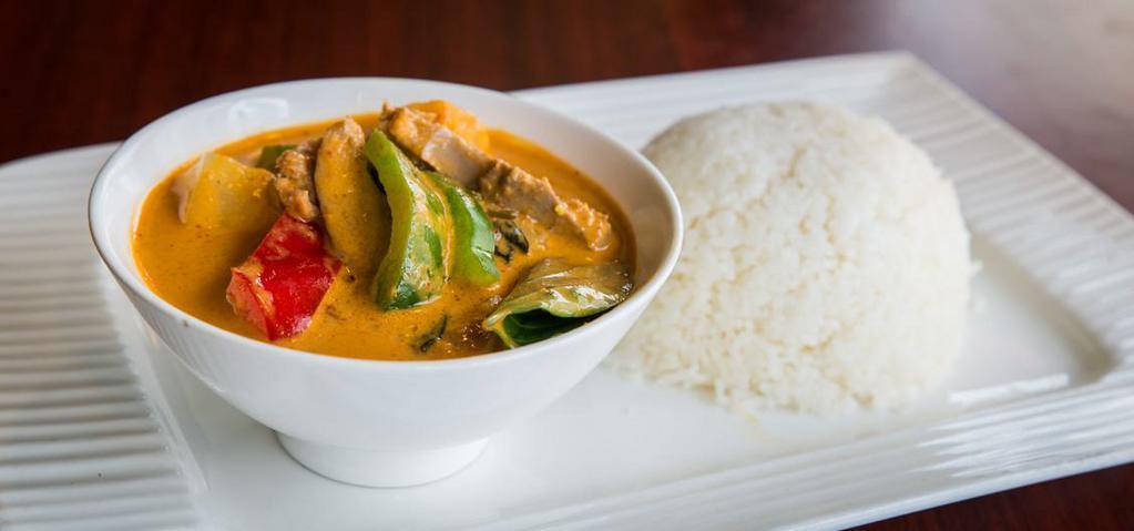 35. Red Curry Over Rice · Medium spicy curry cooked with coconut milk, sweet basil, bell pepper, and bamboo shoot.