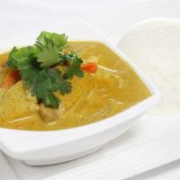 34. Yellow Curry Over Rice · Mild curry with turmeric powder, coconut milk, and potato cubes.