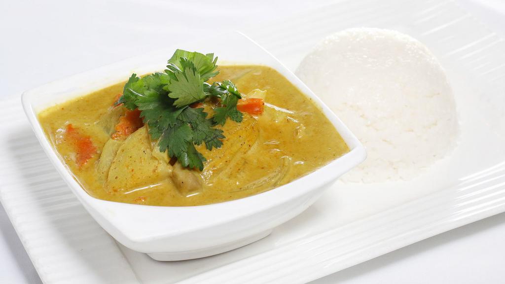 34. Yellow Curry Over Rice · Mild curry with turmeric powder, coconut milk, and potato cubes.