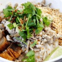 Dry Tom Yum Noodle · Steamed Skinny Rice Noodle with ground pork, slice fish cake, plain Crispy Pork Belly, Peanu...