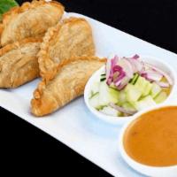 Thai Curry Puff · Thai Traditional Puff Appetizers with Chicken and Curry Powder; served with a cup of cucumbe...