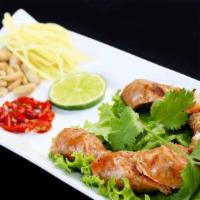 Thai Herb Sausage · Roasted Thai Northern style herb sausage, with peanut, cut ginger, sliced red onion, lemon &...