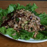 Larb Pork Salad · Minced pork with lime-based salad dressing, chili powder, rice powder, cilantro, and shallot.