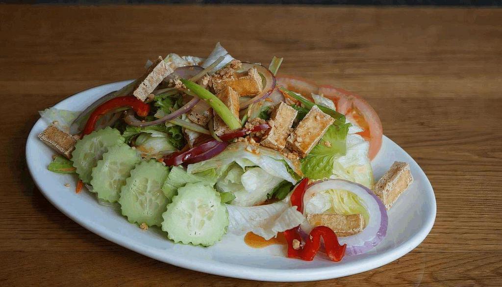 House Green Salad · Fresh mixed greens, tomato, cucumber and topping by fried tofu and peanut salad dressing.