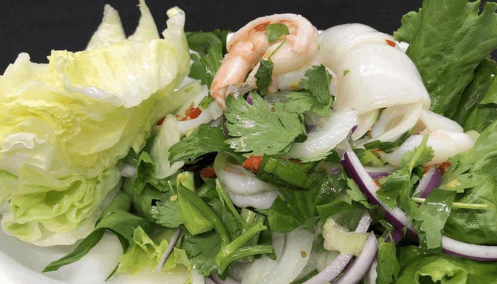 Seafood Salad · Seafood; shrimps, calamari and fish ball mixed in fresh lime based dressing with cilantro, shallot, fresh Thai chili and celery leaves.