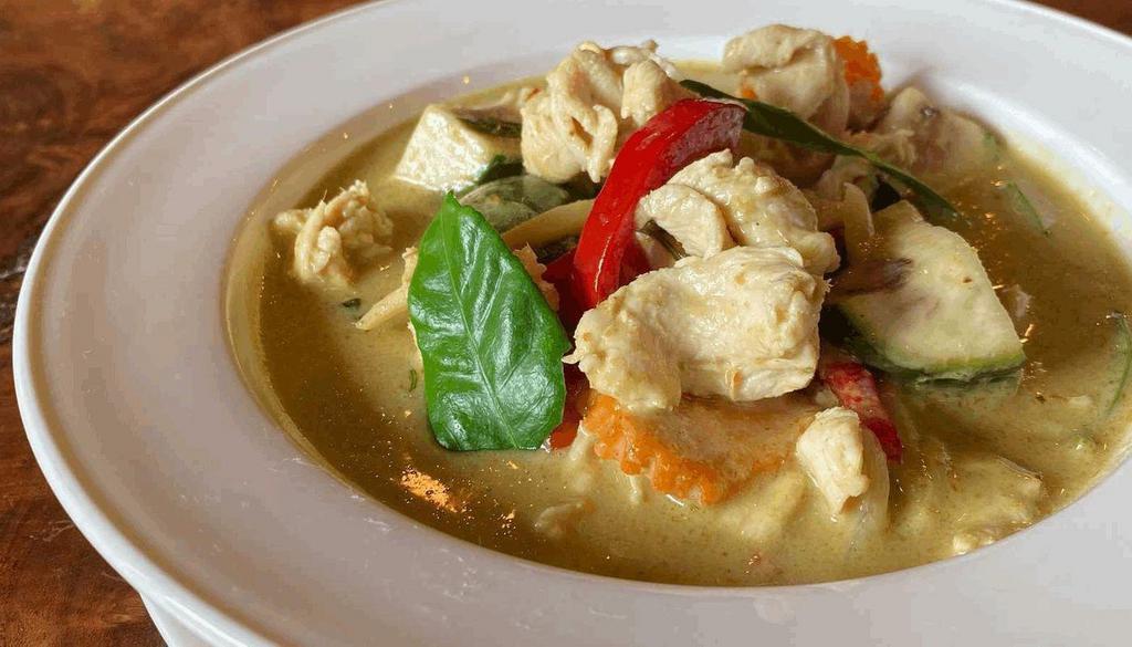 Green Curry · Medium spicy Green curry with Thai Eggplant, bamboo shoot, red Bell peppers and kaffir lime leaves.