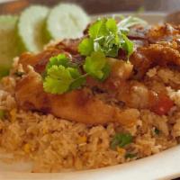 Crispy Chicken Over Fried Rice · Crispy chicken over fried rice, served with sweet chili sauce.