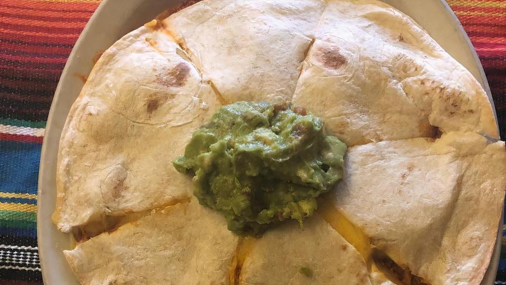 Quesadillas · Flour tortillas stuffed with melted cheese. Served with guacamole and lettuce.
