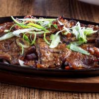Korean Short Ribs · Favorites. Kalbi ribs marinated and grilled in Asian spice, bell pepper, and onions.