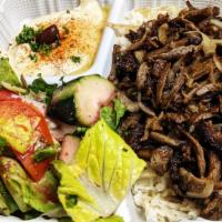 Beef Shawarma Plate · Served with hummus, rice, salad and pita bread.