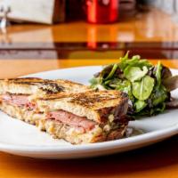 Duck Reuben · Duck confit, pastrami, emmenthal, pickled cabbage, and gribiche aioli.