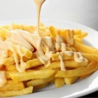 French Fries With Cheese · Golden-crispy fries salted to perfection, topped with melted cheese.