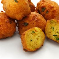 Hush Puppies (7 Pcs) · Piping hot, golden fried, sweet cornmeal balls. Comes with ketchup and hot sauce on the side.