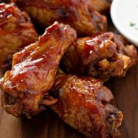 BBQ Wings · Hot N' Crispy Chicken wings, tossed in BBQ sauce and fried to perfection!