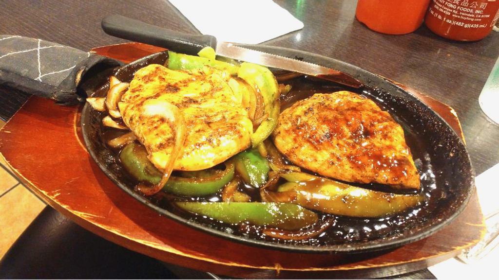 Sizzling Chicken Steak · Grilled chicken breast served on a sizzling plate with onions, bell peppers, and black pepper sauce.