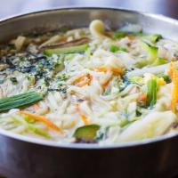 Korean Noodle Soup · Thick flour noodle, scallion, potato, zucchini, onion, and egg.