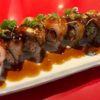 Raider Roll · Salmon skin, cucumber and crab meat, top with red snapper and unagi