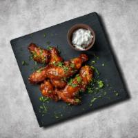 Chicken Garnish Wings · Deep-fried and then coated or dipped in a sauce consisting of pepper hot sauce and melted bu...