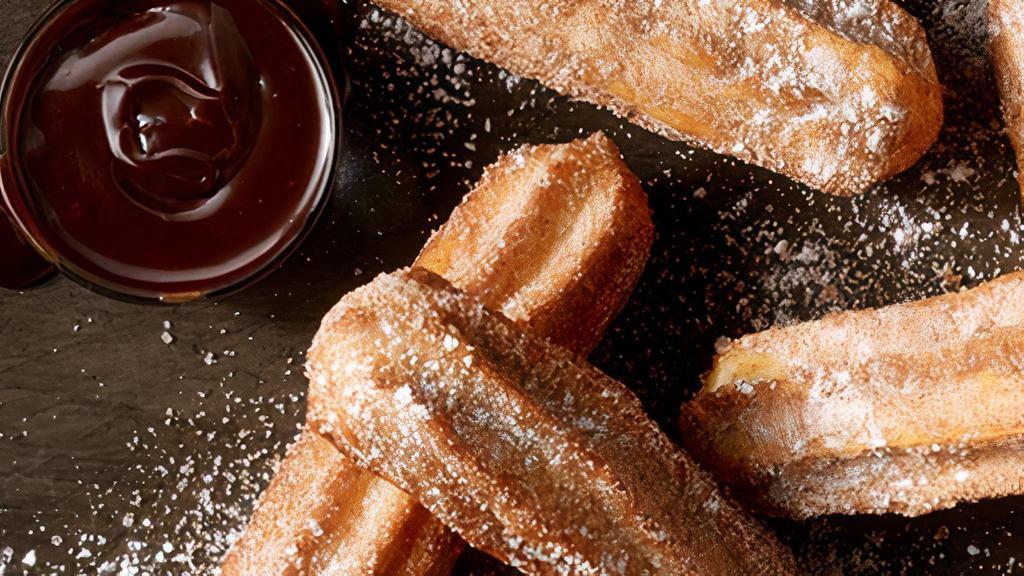 Cinnamon Sugar Churros · Chocolate- and caramel-filled churros with chocolate dipping sauce.
