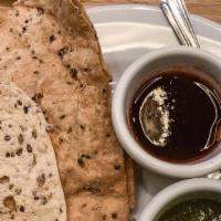 Papadum · Crispy spiced lentil wafers. Served with homemade mint and tamarind chutney.