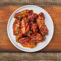 Thai Chicken Wings · (Six pieces) Fresh chicken wings fried until golden brown, and tossed in Thai curry paste, g...
