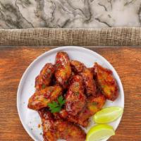 Garlic Honey Wings · (Six pieces) Fresh chicken wings fried until golden brown, and tossed in a garlic honey sauc...