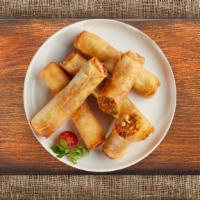 Vegetable Spring Roll · Seasonal vegetables wrapped in rice wrapper and fried until golden crisp. Served with dippin...