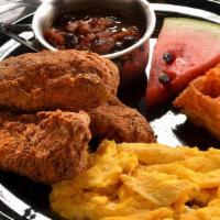 Fried Chicken and Waffles · Crispy fried chicken breast and drumstick with a fluffy Belgian waffle, and served with butt...