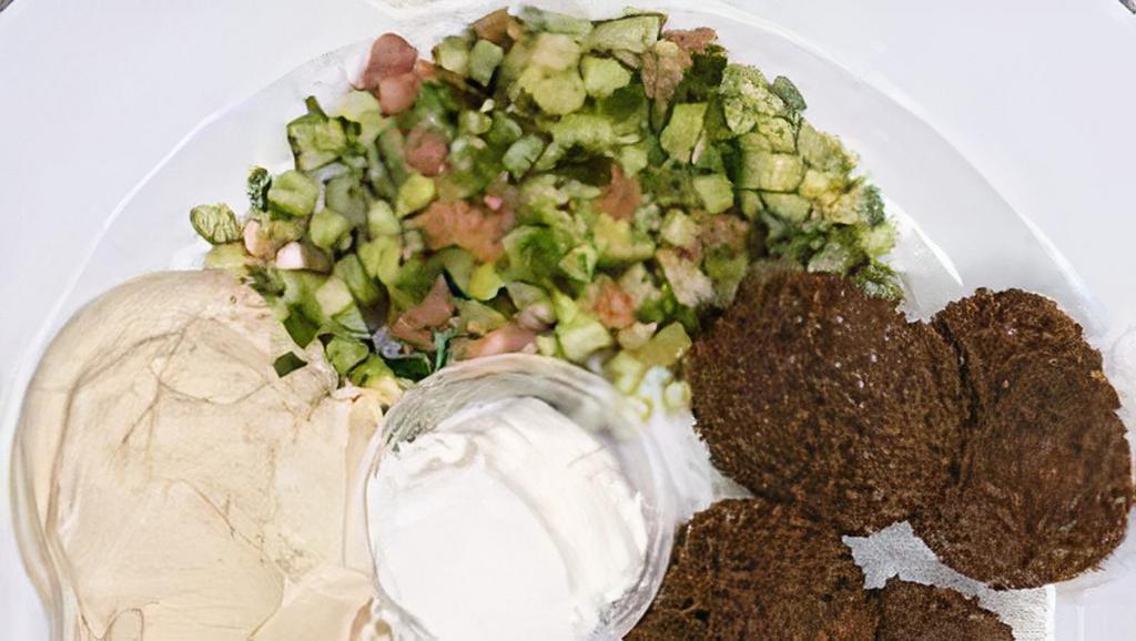 Falafel for Hummus · Eggplant, dolma, hummus, falafel and feta with tahini sauce served on a bed of hummus with lavash bread, salad.