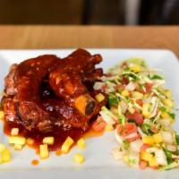 Baby Back Ribs · Tamarindo BBQ ribs served with mango and cabbage slaw
