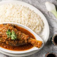 Korma Lamb · Lamb shank cooked with fresh tomatoes, and garlic. Served with white rice.