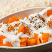 Veggie Borani Kadoo · Butternut pumpkin cooked with garlic, spices, and topped with special homemade yogurt sauce.
