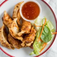 Fried Dumplings · Pan fried dumplings stuffed with grounded chicken, and vegetables; served with thai black be...
