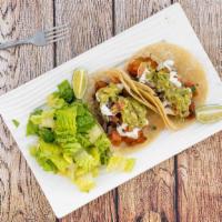 Baja Tacos · 2 tacos with pickled coleslaw, pico de gallo, guacamole,and sour cream with a side salad vin...